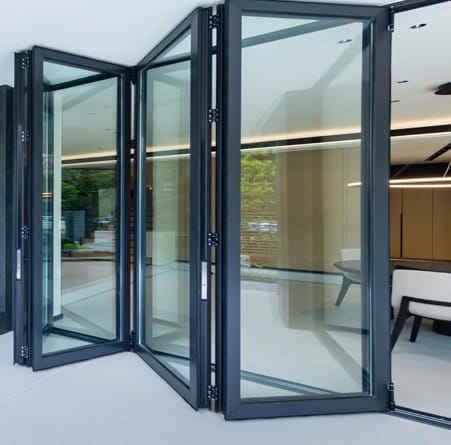 Bi-fold doors folded open between a living room and a terrace