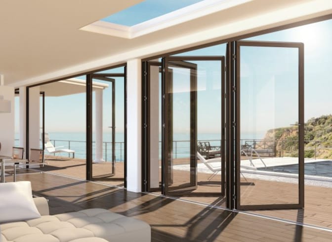 EMD 65 thermal break bi-fold doors opened onto a sea-view terrace
