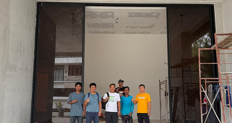 Installation team in front of the TY150 extra-tall sliding door opening, Kuala Lumpur