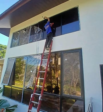 Technician measuring a window opening on site